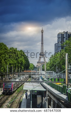 Train station is the transportation is important in the city with the Eiffel Tower , sunlight and cloud  background in Paris,France.