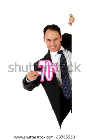 Attractive middle aged caucasian businessman behind a wall showing seventy percent discount sign. Copy space. Studio shot. White background.