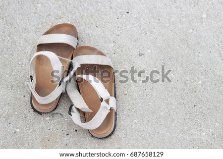 Women is flip-flops on the sandy beach.Summer background.
