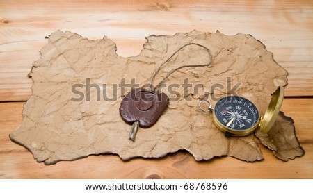 old paper and compass on a wooden background