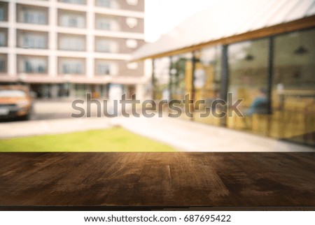 Empty wooden table in front of abstract blurred background of shopping mall . can be used for display or montage your products.Mock up for display of product