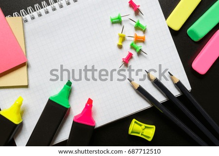 School accessories marker, pencil, scissors, eraser, paper clips, paper, brush on a dark background with copy space. Concept back to school
