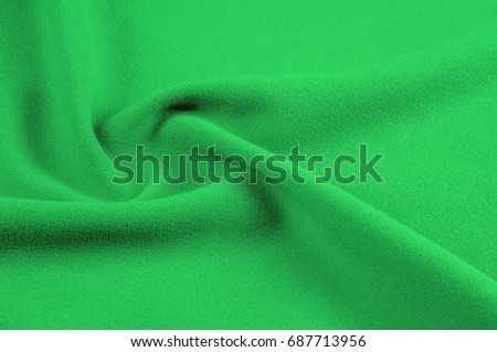 Texture, background, pattern. Green, salad color of silk fabric. Green fabric texture.