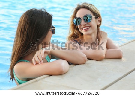 Beautiful young women relaxing in swimming pool
