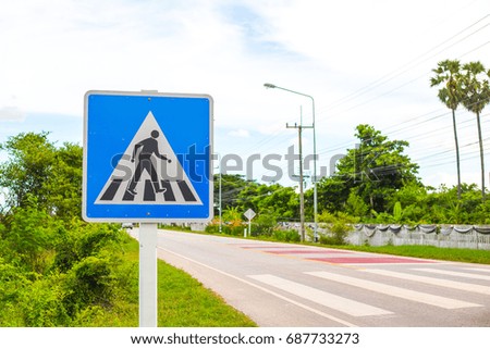 Pedestrian cross warning traffic sign on road