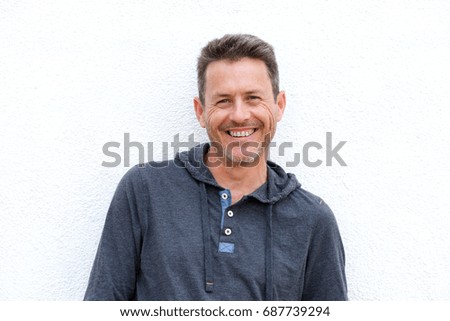 Portrait of smiling older male standing isolated on white background