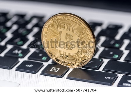 new currency - bitcoin on white laptop keyboard