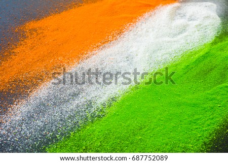 Indian flag tricolors splashed on a dark background. Indian Independence Day background. Royalty-Free Stock Photo #687752089