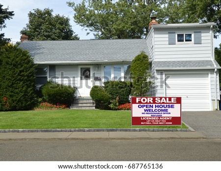 Real Estate for sale sign bungalow split level home USA