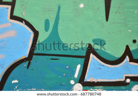Close up view of graffiti drawing details. Background image on the theme of street art and vandalism. Texture of the wall, painted with aerosol paints