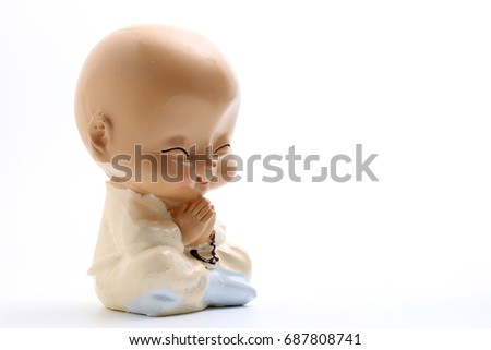 chinese ceramic young monk doll isolate on white background with copy space.