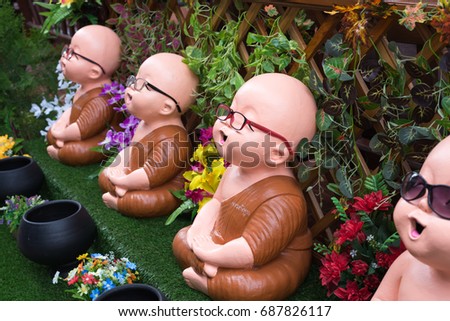 Young monk doll wearing glasses.