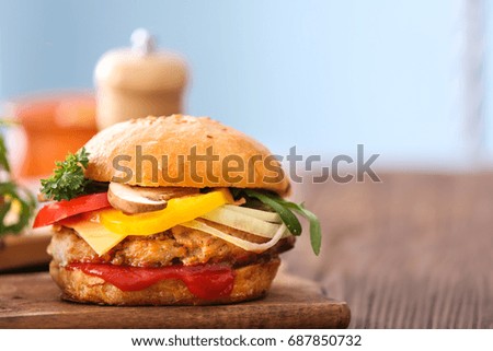 Tasty turkey burger on blurred background