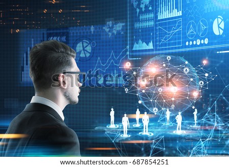 Side view of a young trader wearing glasses looking at an Earth hologram and a bunch of infographics in a futuristic surrounding. Toned image double exposure. Elements of this image furnished by NASA