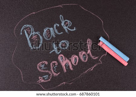 Back to school blackboardchalkboard. writing back to school on black chalk board.