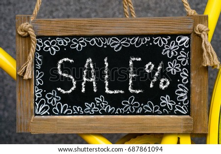 wooden board with word sale written with chalk, signboard. symbol of information, business, marketing and  selling
