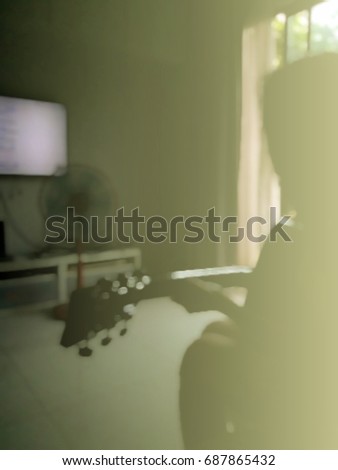 Girl sitting guitar in the room sunlight into the room.