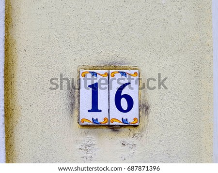 House numbers on the wall sixteen (16)