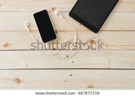 phone blank screen on wood desk on top view, Listen to music