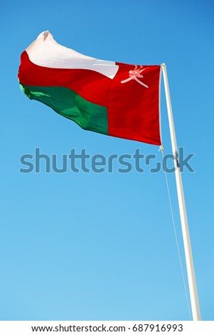  waving flag in oman and the cloudy sky 