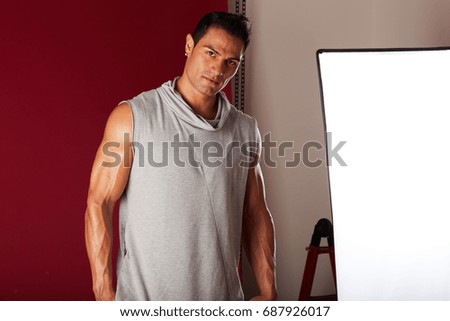 Young beautiful male model posing in professionally equipped studio