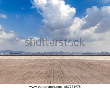 Panoramic skyline and buildings with empty concrete square floor
