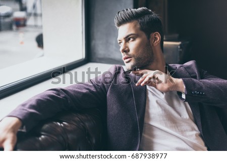 Portrait of handsome caucasian man with fashionable hairstyle at barber shop Royalty-Free Stock Photo #687938977