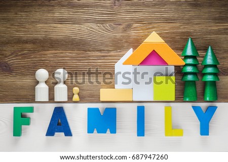 The concept of happy family . Eco construction with green trees, house and family.  Colored word family.