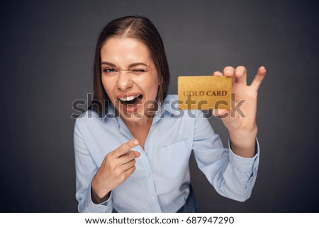 Business woman funny portrait with credit card. Pointing finger.