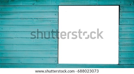 Blank billboard on the green wooden background 