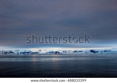 Antarctica landscape, icebergs, mountains and ocean at sunrise, Antarctica