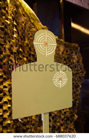 Target for shooting at a dash against the background of a camouflage grid.