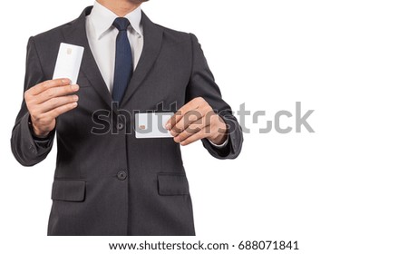 Businessman in black costume suite and necktie reach out on camera and show credit card.