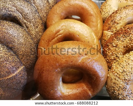 Variety bagels arrange into three loaf. Poppy seed bagel, whole wheat bagel and multigrain bagel picture to decorate the wall or the background of bakery shop.