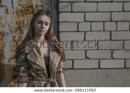 Retro girl near a brick wall