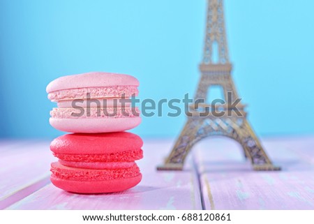 French pastel color macarons with Eiffel Tower background, souvenir from Paris. Romantic Style, Creative for colorful greeting card. Dream Destination. Sweet moment during journey.