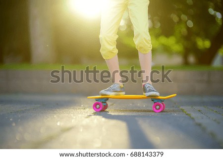 Closeup of skateboarder legs. Kid riding skateboard outdoor. Child practicing outside.