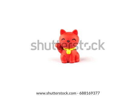 small red japanese cat doll on white background