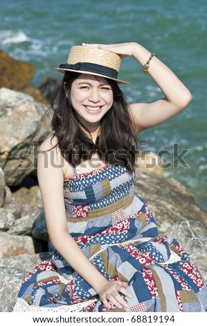 Happy young Asian girl in the sunshine near the beach