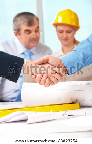 Image of customer and architect handshaking after making an agreement