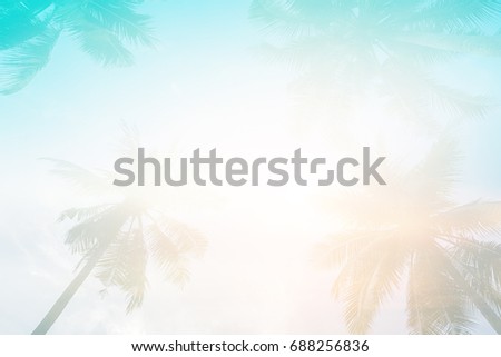 abstract double exposure of blur coconut leaves tropical summer season with sunset skyline wallpaper ,beautiful nature background concept