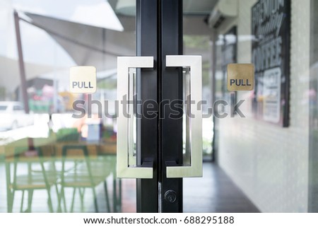 Restaurant door handle with pull sign on glass doors