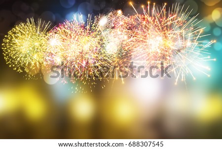 Fireworks on the background are blurred and colorful.