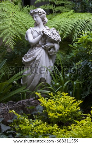 Sculpture of woman in tropical garden, art expression in exterior guatemala.