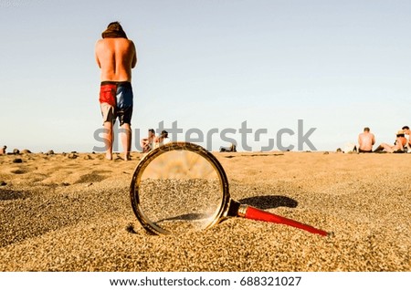 Photo Picture of a Loupe Magnify Glass on the Sand Beach