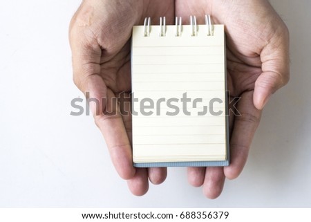 man hold notepad on plaster board  white background. using wallpaper or background for education photo.