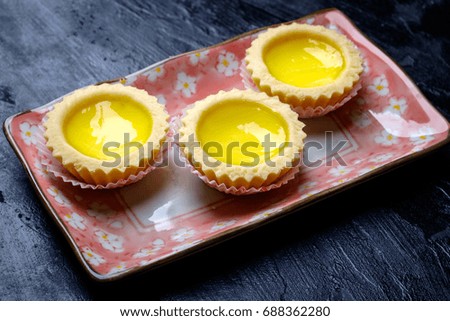 Egg tart closeup on dark textured background