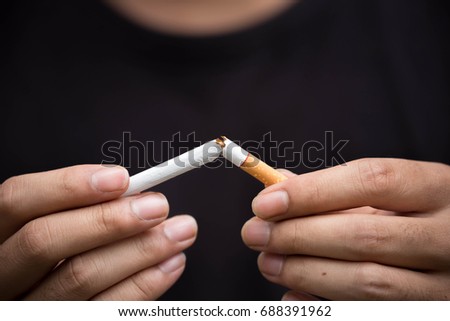 young man crushing cigarette.concept for breaking and quite cigarette for health