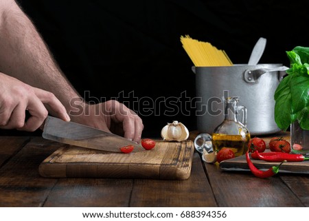 Man cooking an Italian pasta on a wooden table
