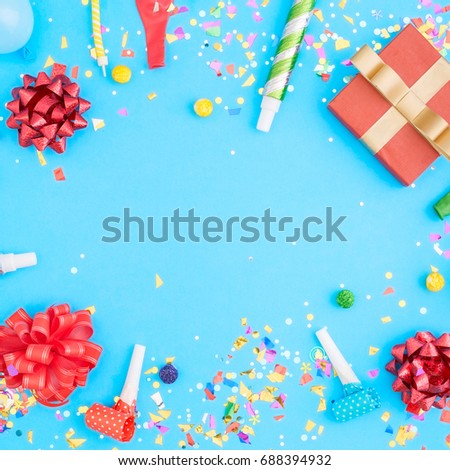 Colorful celebration pattern with various party confetti, balloons, gift box on blue background. Flat lay
